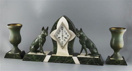 An Art Deco bronze and three colour marble clock garniture, clock width 21.5in. height 12.25in. urns height 9.25in.